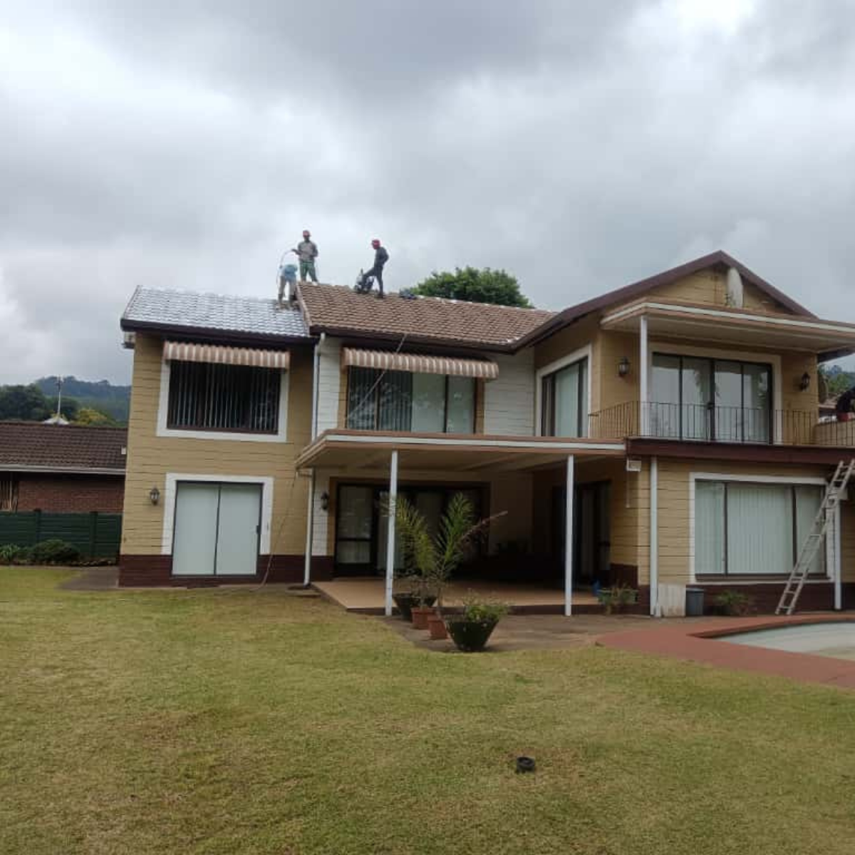 Professional roof painting project completed for a residential home in Wembley, PMB.